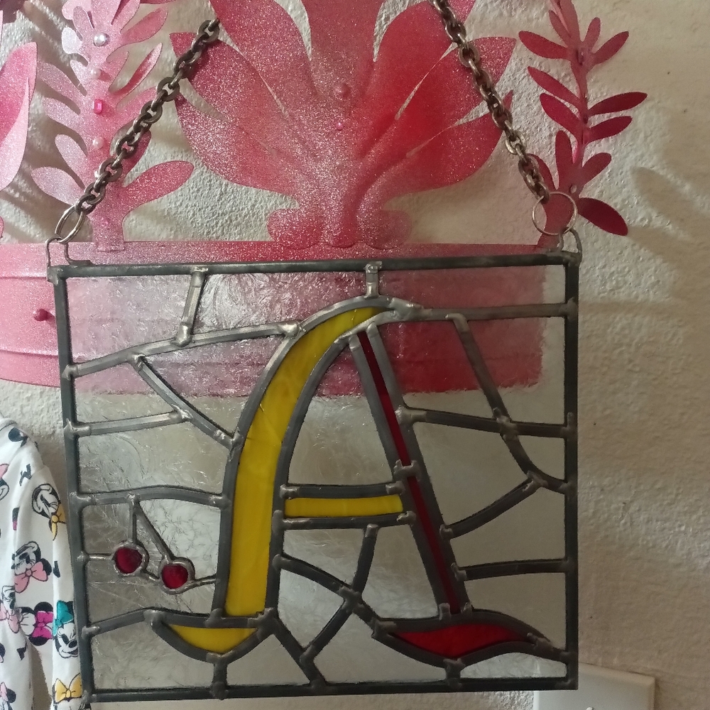 Stained glass letter A with a cherry